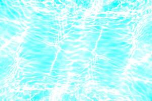Blue water with ripples on the surface. Defocus blurred transparent blue colored clear calm water surface texture with splashes and bubbles. Water waves with shining pattern texture background. photo