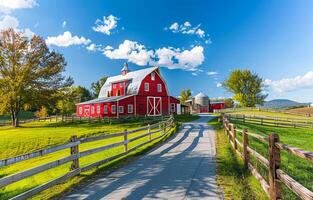 Red barn and silos on farm with dirt road and fenced pastures in rural photo