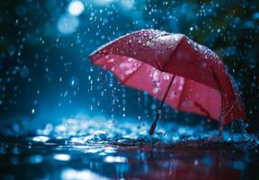 Red umbrella floating in the rain with water droplets splashing around photo