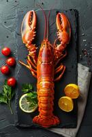 Fresh lobster on black stone plate with lemon tomatoes and parsley photo