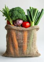 Fresh vegetables in sack. A large net bag filled with vegetables photo