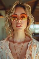 Beautiful young woman in sunglasses is posing in cafe photo