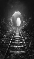 Railway tunnel. A railway tracks and light at the end photo