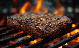 Beef steak on the grill with flames. A grilling steaks on flaming grill photo