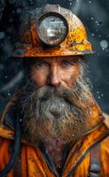 Coal miner with beard and helmet on his head. A photo of an old coal miner with a dirty face