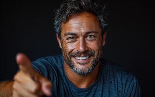 Portrait of mature man pointing finger at camera photo