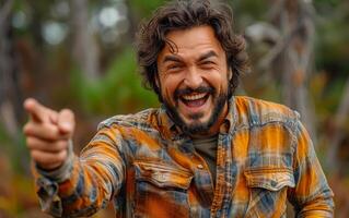 Portrait of happy young man pointing finger at camera photo