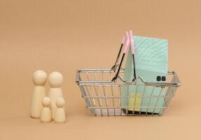 A wooden house in a miniature cart and wooden men of a family with children. photo