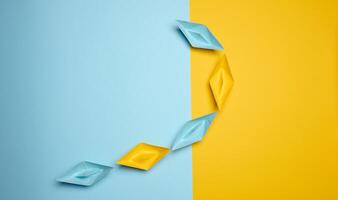 Paper boats on a yellow background, top view, representing the concept of unity and achieving common goals. photo