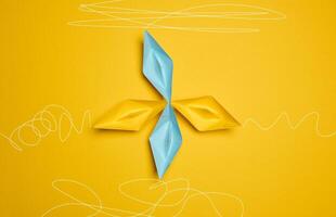 Four paper boats stand at the same departure point, but different trajectories are drawn. The concept of uniqueness photo
