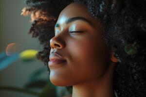 Close-up of a young woman with eyes closed, bathed in warm sunlight, with a sense of calm and peace photo