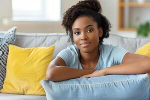 A serene client relaxes on a sofa, ready for an online therapy session photo