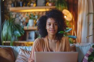 A woman works on her laptop surrounded by plants, creating a vibrant home office photo