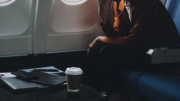 Woman hand using smart phone on airplane. Female traveler using smart phone in passenger cabin. Can be add your texts or others on screen. Sun shining trough airplane window. Technology concept. video