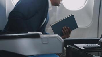 Side view portrait of handsome bearded businessman working while enjoying flight in first class, copy space video