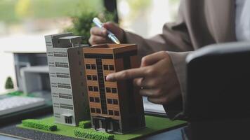 Architecture team and engineer are discussing and brainstorming on floor plan over the clean energy and power saving house design using solar panel for green industry and futuristic home development video
