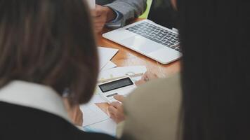 Financial analysts analyze business financial reports on a digital tablet planning investment project during a discussion at a meeting of corporate showing the results of their successful teamwork. video