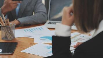 Financial analysts analyze business financial reports on a digital tablet planning investment project during a discussion at a meeting of corporate showing the results of their successful teamwork. video