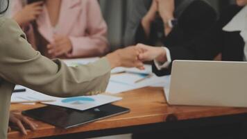 Financial analysts analyze business financial reports on a digital tablet planning investment project during a discussion at a meeting of corporate showing the results of their successful teamwork. video