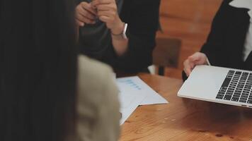 Financial analysts analyze business financial reports on a digital tablet planning investment project during a discussion at a meeting of corporate showing the results of their successful teamwork. video