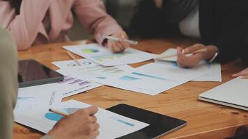 Financial analysts analyze business financial reports on a digital tablet planning investment project during a discussion at a meeting of corporate showing the results of their successful teamwork. video