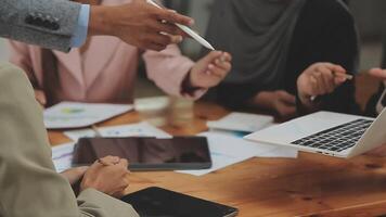 Financial analysts analyze business financial reports on a digital tablet planning investment project during a discussion at a meeting of corporate showing the results of their successful teamwork. video