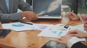 Financial analysts analyze business financial reports on a digital tablet planning investment project during a discussion at a meeting of corporate showing the results of their successful teamwork. video