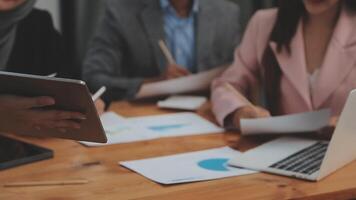 Financial analysts analyze business financial reports on a digital tablet planning investment project during a discussion at a meeting of corporate showing the results of their successful teamwork. video