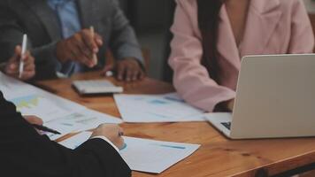 Financial analysts analyze business financial reports on a digital tablet planning investment project during a discussion at a meeting of corporate showing the results of their successful teamwork. video