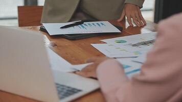 Financial analysts analyze business financial reports on a digital tablet planning investment project during a discussion at a meeting of corporate showing the results of their successful teamwork. video