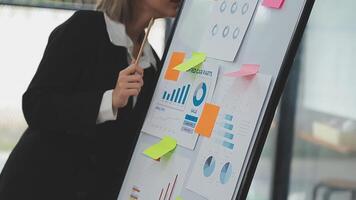 Financial analysts analyze business financial reports on a digital tablet planning investment project during a discussion at a meeting of corporate showing the results of their successful teamwork. video