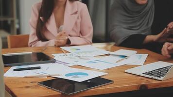 Financial analysts analyze business financial reports on a digital tablet planning investment project during a discussion at a meeting of corporate showing the results of their successful teamwork. video