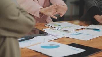 Financial analysts analyze business financial reports on a digital tablet planning investment project during a discussion at a meeting of corporate showing the results of their successful teamwork. video