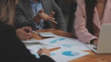Financial analysts analyze business financial reports on a digital tablet planning investment project during a discussion at a meeting of corporate showing the results of their successful teamwork. video