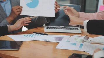 Financial analysts analyze business financial reports on a digital tablet planning investment project during a discussion at a meeting of corporate showing the results of their successful teamwork. video