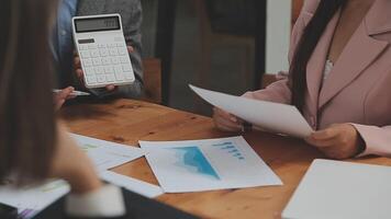 Financial analysts analyze business financial reports on a digital tablet planning investment project during a discussion at a meeting of corporate showing the results of their successful teamwork. video