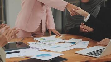 Financial analysts analyze business financial reports on a digital tablet planning investment project during a discussion at a meeting of corporate showing the results of their successful teamwork. video