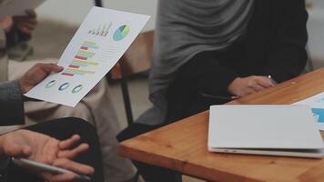Financial analysts analyze business financial reports on a digital tablet planning investment project during a discussion at a meeting of corporate showing the results of their successful teamwork. video