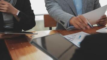 Financial analysts analyze business financial reports on a digital tablet planning investment project during a discussion at a meeting of corporate showing the results of their successful teamwork. video