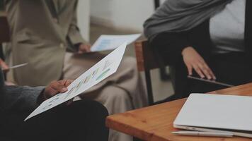 Financial analysts analyze business financial reports on a digital tablet planning investment project during a discussion at a meeting of corporate showing the results of their successful teamwork. video