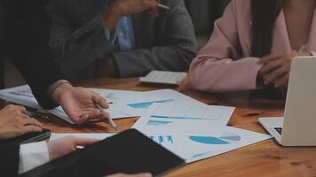 Financial analysts analyze business financial reports on a digital tablet planning investment project during a discussion at a meeting of corporate showing the results of their successful teamwork. video