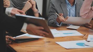 Financial analysts analyze business financial reports on a digital tablet planning investment project during a discussion at a meeting of corporate showing the results of their successful teamwork. video