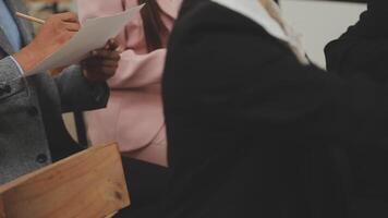 Financial analysts analyze business financial reports on a digital tablet planning investment project during a discussion at a meeting of corporate showing the results of their successful teamwork. video