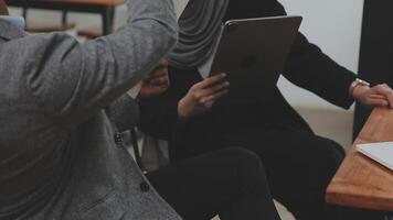 Financial analysts analyze business financial reports on a digital tablet planning investment project during a discussion at a meeting of corporate showing the results of their successful teamwork. video