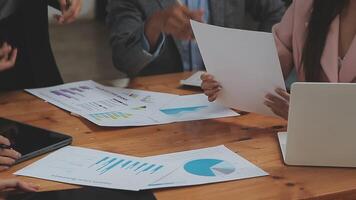 Financial analysts analyze business financial reports on a digital tablet planning investment project during a discussion at a meeting of corporate showing the results of their successful teamwork. video