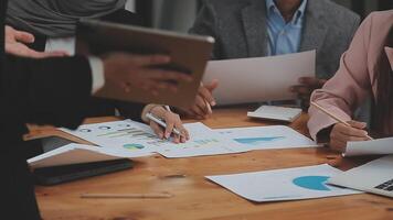 Financial analysts analyze business financial reports on a digital tablet planning investment project during a discussion at a meeting of corporate showing the results of their successful teamwork. video