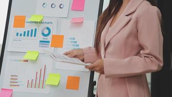 Financial analysts analyze business financial reports on a digital tablet planning investment project during a discussion at a meeting of corporate showing the results of their successful teamwork. video