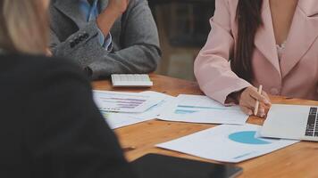 Financial analysts analyze business financial reports on a digital tablet planning investment project during a discussion at a meeting of corporate showing the results of their successful teamwork. video