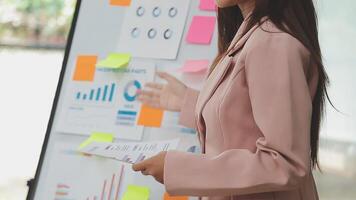 Financial analysts analyze business financial reports on a digital tablet planning investment project during a discussion at a meeting of corporate showing the results of their successful teamwork. video