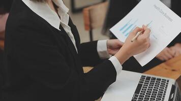 Financial analysts analyze business financial reports on a digital tablet planning investment project during a discussion at a meeting of corporate showing the results of their successful teamwork. video